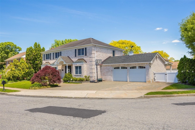 30 Knoll Ln, Glen Head, NY 11545 - view of front of house with an attached garage, a gate, driveway, and brick siding