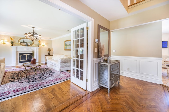 30 Knoll Ln, Glen Head, NY 11545 - living area with a chandelier, crown molding, a wainscoted wall, and a premium fireplace