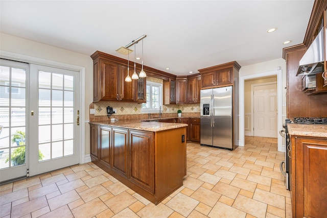 30 Knoll Ln, Glen Head, NY 11545 - kitchen featuring stainless steel fridge, a peninsula, backsplash, a sink, and light stone counters