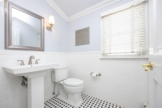 30 Knoll Ln, Glen Head, NY 11545 - half bathroom featuring ornamental molding, toilet, tile walls, wainscoting, and a sink