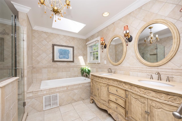 30 Knoll Ln, Glen Head, NY 11545 - full bathroom with a chandelier, crown molding, double vanity, tile patterned floors, and a skylight
