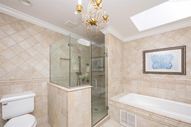30 Knoll Ln, Glen Head, NY 11545 - bathroom featuring tile walls, a skylight, a bath, toilet, and ornamental molding