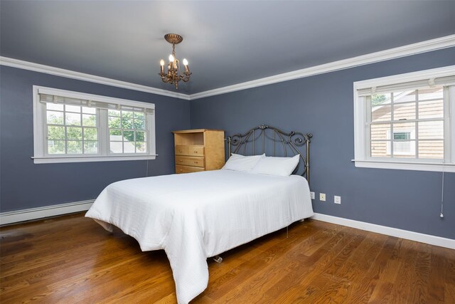 30 Knoll Ln, Glen Head, NY 11545 - bedroom featuring a chandelier, crown molding, multiple windows, wood finished floors, and baseboard heating