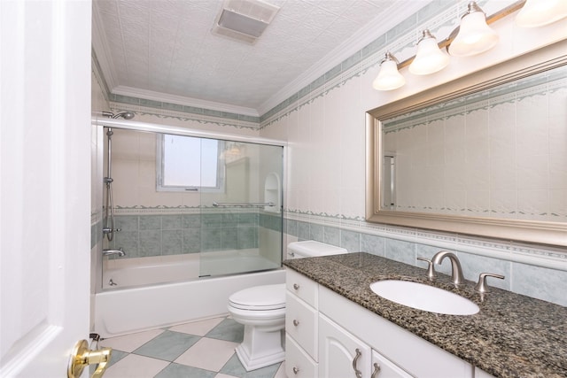 30 Knoll Ln, Glen Head, NY 11545 - full bath featuring crown molding, toilet, vanity, combined bath / shower with glass door, and tile walls