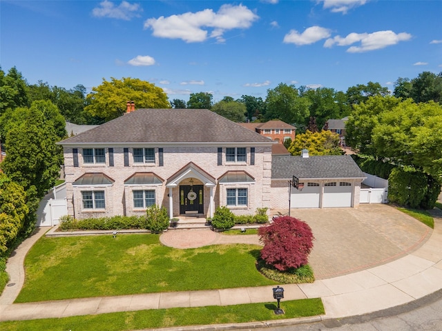 30 Knoll Ln, Glen Head, NY 11545 - view of front of house with a chimney, driveway, a garage, and view of scattered trees