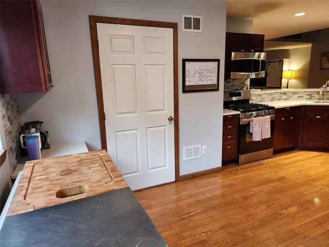 182 Ledge Rd, Kingston, NY 12401 - kitchen with appliances with stainless steel finishes, tasteful backsplash, light wood finished floors, light countertops, and a sink
