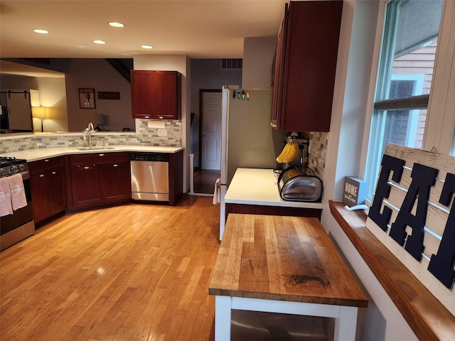 182 Ledge Rd, Kingston, NY 12401 - kitchen with stainless steel appliances, a sink, decorative backsplash, light wood-style floors, and recessed lighting