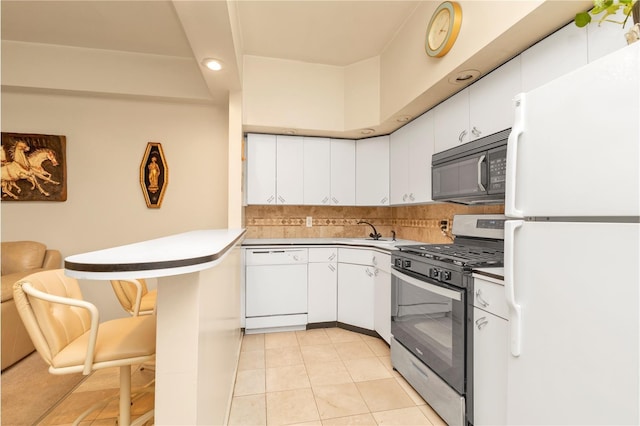 160-15 Powells Cove Blvd Unit D203, Beechhurst, NY 11357 - kitchen featuring white appliances, white cabinets, a sink, backsplash, and a breakfast bar area