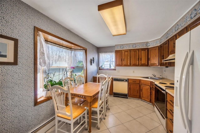 383 Old Country Rd, Deer Park, NY 11729 - kitchen with white appliances, under cabinet range hood, light countertops, wallpapered walls, and light tile patterned floors