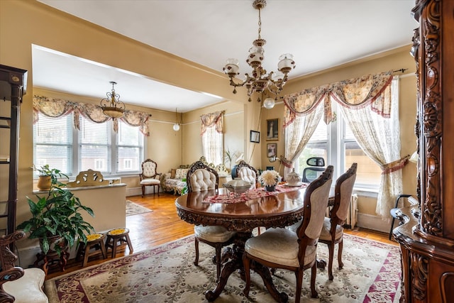 1358 E 35th St, Brooklyn, NY 11210 - dining room with a chandelier, light wood-style floors, and ornamental molding