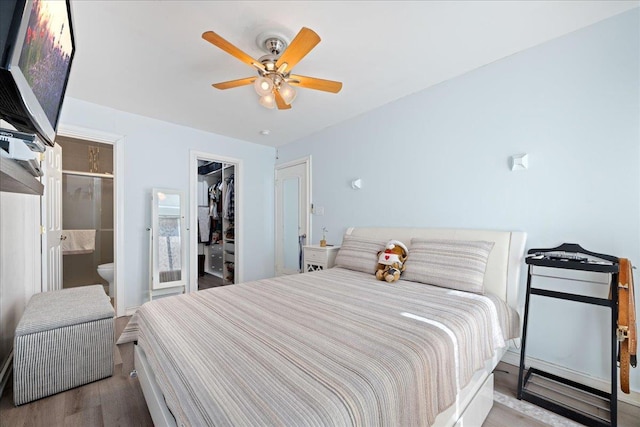 133-20 87th St Unit 3, Ozone Park, NY 11417 - bedroom featuring wood finished floors, connected bathroom, a ceiling fan, a closet, and a walk in closet
