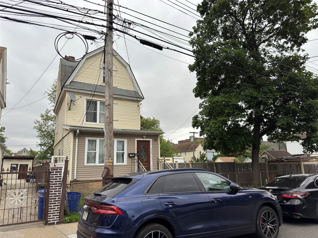 117-67 140th St, Jamaica, NY 11420 - view of front of home featuring a chimney and a gambrel roof