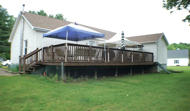 26 Saunders Ln, Wawarsing, NY 12489 - rear view of property featuring a shingled roof, a lawn, and a deck