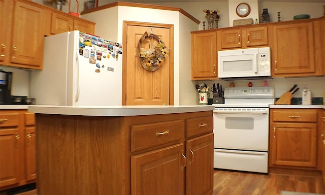 26 Saunders Ln, Wawarsing, NY 12489 - kitchen featuring white appliances, light countertops, light wood-type flooring, and brown cabinets