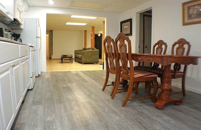 26 Saunders Ln, Wawarsing, NY 12489 - dining area with light wood-style floors, a paneled ceiling, and baseboards