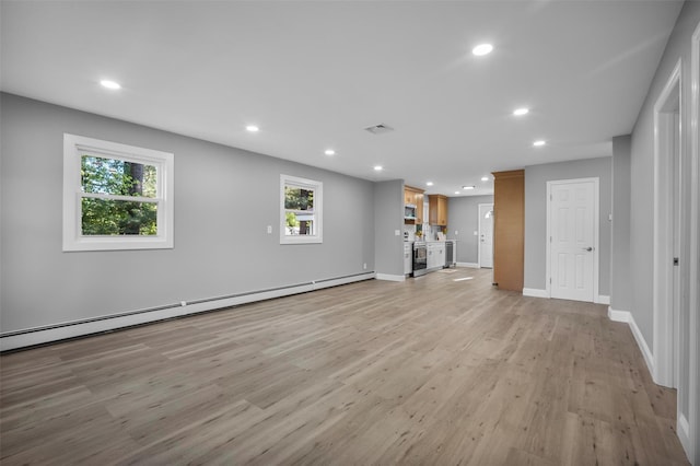 1345 Rte 82, Hopewell Junction, NY 12533 - unfurnished living room featuring recessed lighting, light wood-style flooring, plenty of natural light, baseboards, and a baseboard radiator
