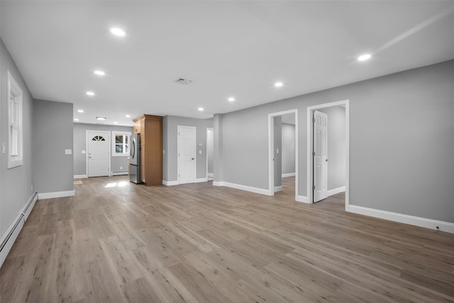 1345 Rte 82, Hopewell Junction, NY 12533 - unfurnished living room with baseboard heating, recessed lighting, light wood finished floors, and baseboards