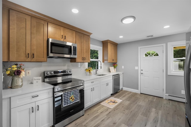 1345 Rte 82, Hopewell Junction, NY 12533 - kitchen featuring appliances with stainless steel finishes, a baseboard radiator, light wood finished floors, light countertops, and recessed lighting