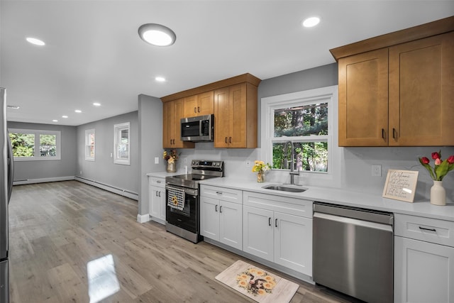 1345 Rte 82, Hopewell Junction, NY 12533 - kitchen featuring stainless steel appliances, a baseboard radiator, a sink, light countertops, and recessed lighting