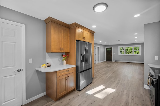 1345 Rte 82, Hopewell Junction, NY 12533 - kitchen with stainless steel refrigerator with ice dispenser, brown cabinetry, light wood-style flooring, light countertops, and a baseboard heating unit