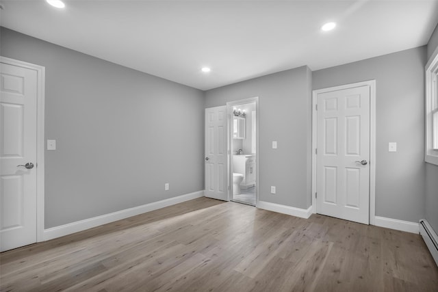 1345 Rte 82, Hopewell Junction, NY 12533 - unfurnished bedroom with light wood-style floors, baseboards, recessed lighting, ensuite bath, and a baseboard heating unit