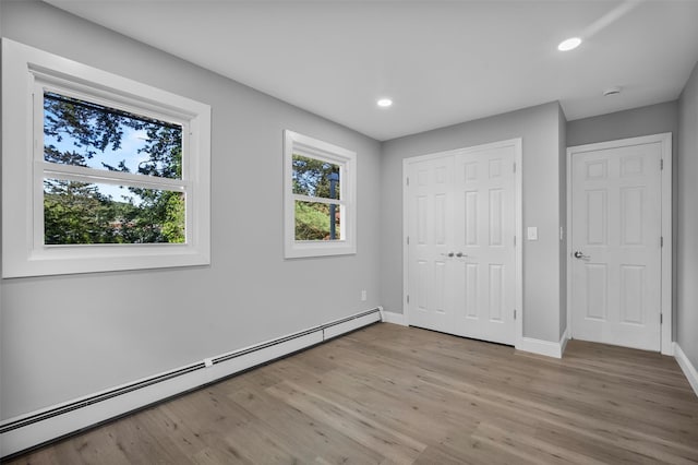 1345 Rte 82, Hopewell Junction, NY 12533 - unfurnished bedroom with a baseboard heating unit, light wood-type flooring, baseboards, recessed lighting, and a closet