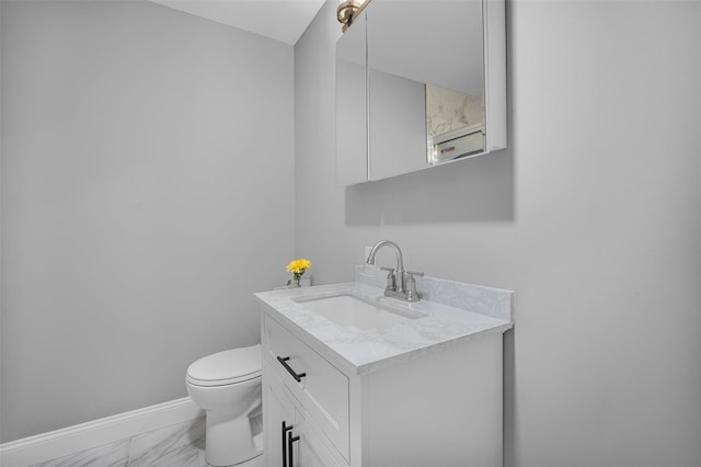 1345 Rte 82, Hopewell Junction, NY 12533 - bathroom with marble look tile flooring, vanity, toilet, and baseboards