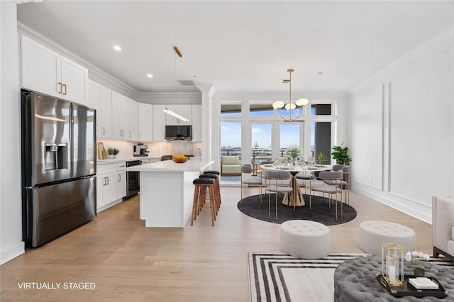 90 Bay Street Lndg Unit 6L, Staten Island, NY 10301 - kitchen with stainless steel appliances, a kitchen bar, light wood-type flooring, white cabinetry, and wine cooler