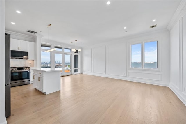 90 Bay Street Lndg Unit 6L, Staten Island, NY 10301 - kitchen featuring stainless steel appliances, a decorative wall, a chandelier, white cabinetry, and light countertops