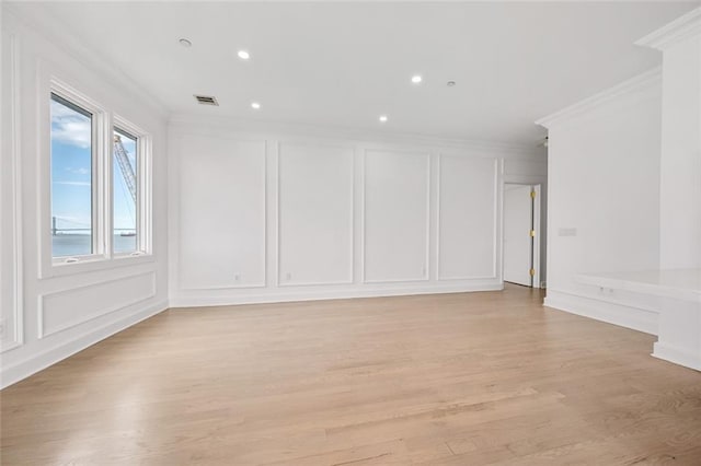 90 Bay Street Lndg Unit 6L, Staten Island, NY 10301 - spare room featuring a decorative wall, ornamental molding, light wood-style floors, and recessed lighting