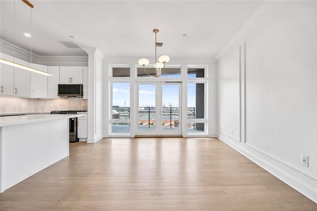 90 Bay Street Lndg Unit 6L, Staten Island, NY 10301 - kitchen featuring stainless steel appliances, ornamental molding, a chandelier, light wood-style floors, and backsplash