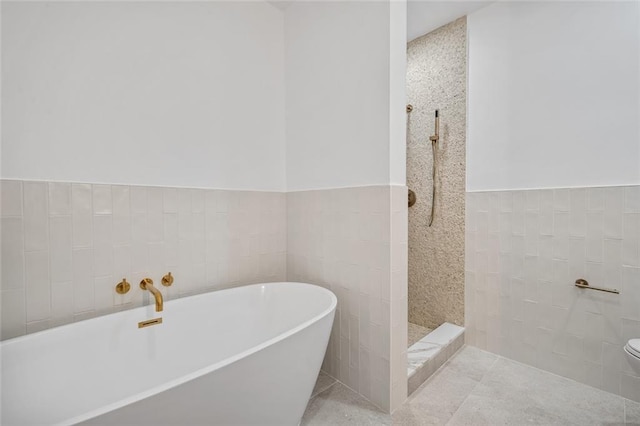 90 Bay Street Lndg Unit 6L, Staten Island, NY 10301 - full bathroom featuring a freestanding bath, toilet, tile walls, a tile shower, and wainscoting