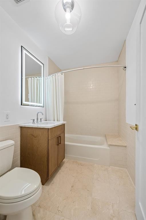 90 Bay Street Lndg Unit 6L, Staten Island, NY 10301 - bathroom featuring vanity, toilet, shower / bath combo with shower curtain, marble finish floors, and tile walls
