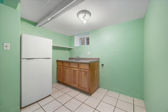 40-14 79th St, Elmhurst, NY 11373 - kitchen with freestanding refrigerator, brown cabinetry, open shelves, a sink, and light tile patterned flooring