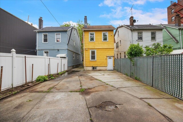 40-14 79th St, Elmhurst, NY 11373 - back of property featuring a patio area and a fenced backyard