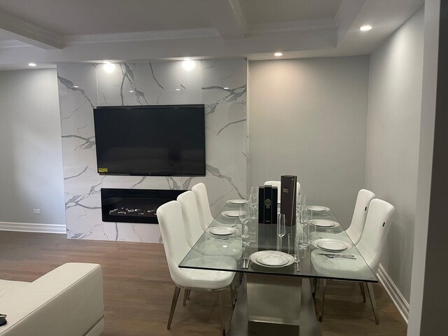 67-66 108th St Unit D5, Forest Hills, NY 11375 - dining area featuring ornamental molding, recessed lighting, wood finished floors, baseboards, and a high end fireplace