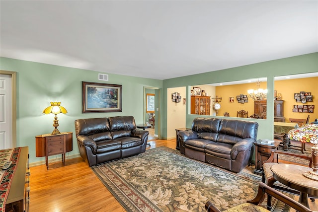 105 Browns Rd, Nesconset, NY 11767 - living area featuring a chandelier, light wood finished floors, and baseboards
