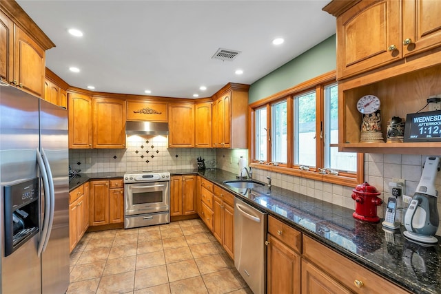 105 Browns Rd, Nesconset, NY 11767 - kitchen featuring stainless steel appliances, a sink, exhaust hood, brown cabinets, and tasteful backsplash