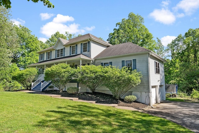 30 Airport Rd, Warwick, NY 10990 - colonial-style house with a trampoline, a garage, asphalt driveway, a front lawn, and covered porch