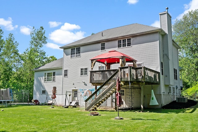 30 Airport Rd, Warwick, NY 10990 - back of property featuring a trampoline, a wooden deck, a chimney, a fire pit, and stairway