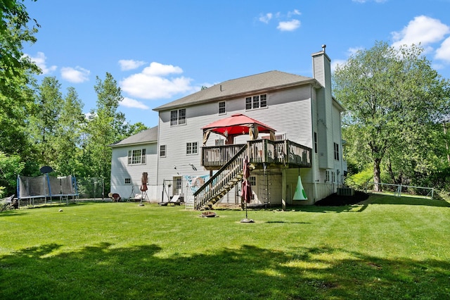 30 Airport Rd, Warwick, NY 10990 - rear view of property with a trampoline, stairway, a wooden deck, a chimney, and a lawn
