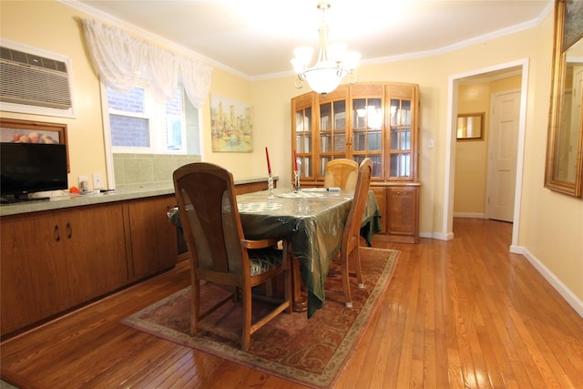 73-20 52nd Rd, Maspeth, NY 11378 - dining area featuring a chandelier, light wood-type flooring, a wall unit AC, crown molding, and baseboards