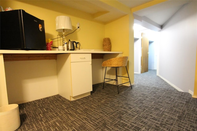 73-20 52nd Rd, Maspeth, NY 11378 - kitchen with freestanding refrigerator, dark colored carpet, and white cabinetry