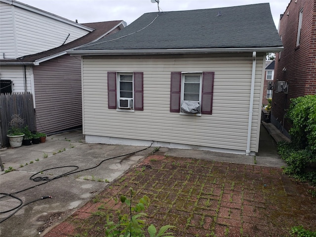 73-20 52nd Rd, Maspeth, NY 11378 - back of property with a patio and a shingled roof