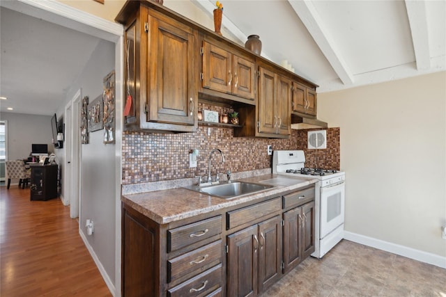 244 Laverne Ave, Holbrook, NY 11741 - kitchen featuring gas range gas stove, a sink, backsplash, under cabinet range hood, and baseboards