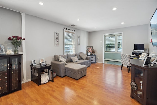 244 Laverne Ave, Holbrook, NY 11741 - living room featuring a baseboard heating unit, light wood finished floors, plenty of natural light, and recessed lighting