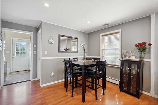 244 Laverne Ave, Holbrook, NY 11741 - dining space with wood finished floors, baseboards, recessed lighting, and a baseboard radiator