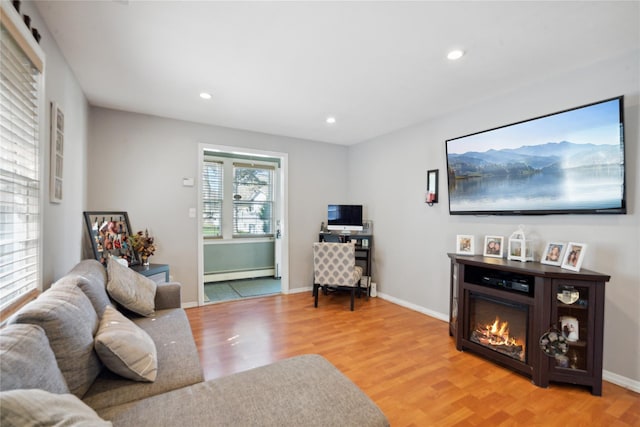 244 Laverne Ave, Holbrook, NY 11741 - living area with a baseboard heating unit, light wood-style flooring, recessed lighting, and baseboards