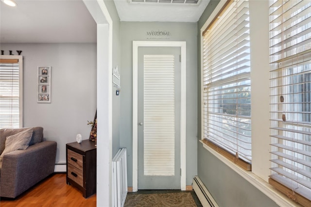 244 Laverne Ave, Holbrook, NY 11741 - entryway with baseboard heating and wood finished floors