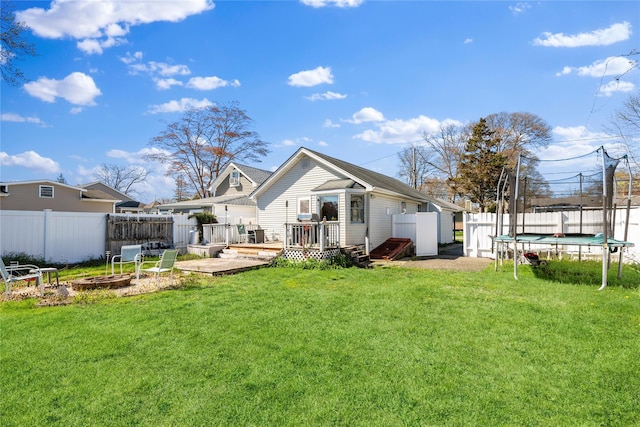 244 Laverne Ave, Holbrook, NY 11741 - rear view of house featuring a trampoline and a deck